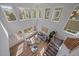 Bright living room boasts many windows, hardwood floors, and comfortable seating area at 5586 S Harlan St, Littleton, CO 80123