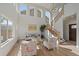Bright living room featuring a modern staircase, wood floors, and lots of natural light at 5586 S Harlan St, Littleton, CO 80123