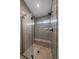 Modern shower with gray tiled walls, built-in bench, and glass enclosure at 5586 S Harlan St, Littleton, CO 80123