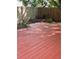 Private backyard featuring a wood deck, flower garden, and wood privacy fence at 9008 W 101St Ave, Broomfield, CO 80021