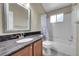 Bathroom with wood cabinets, granite countertop and a shower and tub combo at 9008 W 101St Ave, Broomfield, CO 80021
