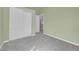 A bedroom with light green walls, gray carpet and sliding closet doors at 9008 W 101St Ave, Broomfield, CO 80021