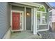 Inviting entryway featuring a red front door, white columns, and tasteful outdoor decor at 9008 W 101St Ave, Broomfield, CO 80021