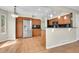 Well-lit kitchen with stainless steel appliances, wooden cabinetry, and hardwood floors at 9008 W 101St Ave, Broomfield, CO 80021