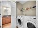 Laundry area with washer and dryer featuring a view into the adjacent half bath at 9008 W 101St Ave, Broomfield, CO 80021