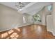 Vaulted living room showcasing hardwood floors, a chandelier and abundant natural light at 9008 W 101St Ave, Broomfield, CO 80021
