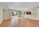 Bright living room with hardwood floors, sliding doors, and open access to the kitchen breakfast bar at 9008 W 101St Ave, Broomfield, CO 80021