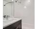 This bright bathroom includes a dark vanity, tub, and rain style showerhead at 2833 W 25Th Ave # 5, Denver, CO 80211