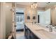 The dual sink bathroom includes a shower and a view into the main bedroom at 2833 W 25Th Ave # 5, Denver, CO 80211