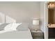 This bedroom is decorated with a lamp and dresser, as well as a view of the en suite bathroom at 2833 W 25Th Ave # 5, Denver, CO 80211