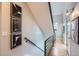 Hallway includes wood floors, metal railing, and modern black and white decor at 2833 W 25Th Ave # 5, Denver, CO 80211