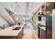 Open-concept kitchen featuring a large island with counter seating and stainless steel appliances at 2833 W 25Th Ave # 5, Denver, CO 80211