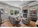 Cozy living room with a modern fireplace, mounted TV, sliding door access to a deck, and hardwood floors at 2833 W 25Th Ave # 5, Denver, CO 80211