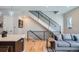 Open-concept living area with a modern staircase, hardwood floors, and contemporary design elements at 2833 W 25Th Ave # 5, Denver, CO 80211