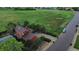 Red house with spacious driveway, nicely landscaped yard, backing onto a large field in a quiet neighborhood at 4664 S Union St, Morrison, CO 80465