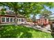 Relaxing backyard with a shed, mature shade tree, and a fire pit with comfortable chairs at 4664 S Union St, Morrison, CO 80465