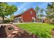 This backyard features mature trees, a grassy lawn, a patio and a BBQ at 4664 S Union St, Morrison, CO 80465