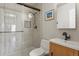 Modern bathroom with glass shower doors, a white vanity, and neutral toned walls at 4664 S Union St, Morrison, CO 80465