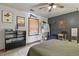 Unique bedroom with a dark accent wall, light gray walls, and wood trim around the window at 4664 S Union St, Morrison, CO 80465