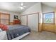 Cozy bedroom with vaulted ceiling, two closets, and warm wood trim around window and doors at 4664 S Union St, Morrison, CO 80465