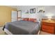 Comfortable bedroom featuring wood trim and light-colored walls and carpet at 4664 S Union St, Morrison, CO 80465
