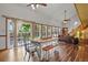 Dining area with a farm table, backyard views, and an open-concept to the living room at 4664 S Union St, Morrison, CO 80465