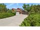 Charming two-story home with a large driveway, mature trees, and professionally landscaped yard at 4664 S Union St, Morrison, CO 80465