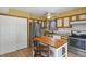 Charming kitchen featuring light and wood cabinets, stainless steel refrigerator, and a butcher block island at 4664 S Union St, Morrison, CO 80465