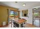Bright kitchen featuring a central island with seating and a sliding door to the outdoor patio at 4664 S Union St, Morrison, CO 80465