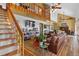 Spacious living room featuring high ceilings, a loft, and hardwood floors with rustic furnishings at 4664 S Union St, Morrison, CO 80465