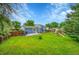 Expansive backyard with lush lawn, wooden fence, deck, and playset, perfect for outdoor enjoyment at 4259 S Richfield St, Aurora, CO 80013