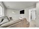A cozy basement living room features a leather sofa, a large television, and neutral tones at 4259 S Richfield St, Aurora, CO 80013