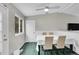 Bright dining area with a large window, tiled floor, and access to the outside at 4259 S Richfield St, Aurora, CO 80013