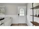 Bright entryway featuring a stylish door, wood floors, and sleek shelving at 4259 S Richfield St, Aurora, CO 80013