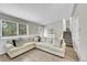 Living room featuring a large sectional sofa, big window and staircase access at 4259 S Richfield St, Aurora, CO 80013
