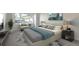 Comfortable primary bedroom with a large window, chair, and stylish furnishings at 12593 E Pacific Cir # E, Aurora, CO 80014