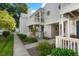 Charming two-story townhome featuring a private balcony, blue front door, and well-maintained landscaping at 12593 E Pacific Cir # E, Aurora, CO 80014