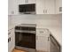 Modern kitchen with stainless steel appliances, white cabinets, and quartz countertops, perfect for cooking and entertaining at 12593 E Pacific Cir # E, Aurora, CO 80014