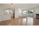 Open-concept living room featuring hardwood floors, updated kitchen, and fireplace at 12593 E Pacific Cir # E, Aurora, CO 80014