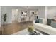Open-concept living area with dining space, kitchen view, and modern decor with lots of light at 12593 E Pacific Cir # E, Aurora, CO 80014