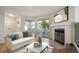 Bright living room features a fireplace, sliding glass doors to the outside, and contemporary decor at 12593 E Pacific Cir # E, Aurora, CO 80014
