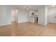 Bright living room with hardwood floors next to kitchen and doorways to bedrooms at 12593 E Pacific Cir # E, Aurora, CO 80014
