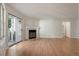 Spacious living room features hardwood flooring, fireplace and access to patio at 12593 E Pacific Cir # E, Aurora, CO 80014
