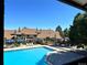 Exterior view of a community pool with lounge chairs, tables, and blue umbrellas at 12593 E Pacific Cir # E, Aurora, CO 80014