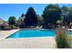 View of the community pool with lounge seating, landscaping, and a clear blue sky at 12593 E Pacific Cir # E, Aurora, CO 80014