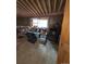 Spacious room with exposed ceiling beams, ample natural light, and some storage items at 325 Aspen Rd, Idaho Springs, CO 80452