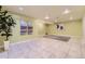 Spacious basement area with tile flooring and modern artwork, perfect for entertaining or relaxing at 9742 E Hawaii Pl, Aurora, CO 80247