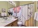 Bright bathroom featuring a vessel sink, decorative shower curtain, and modern decor at 9742 E Hawaii Pl, Aurora, CO 80247