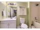 A bathroom featuring a single sink vanity, shower and tub combination, and tiled walls at 9742 E Hawaii Pl, Aurora, CO 80247