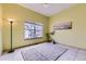 Bright and open bedroom with a large window, light-colored walls, and tile flooring at 9742 E Hawaii Pl, Aurora, CO 80247